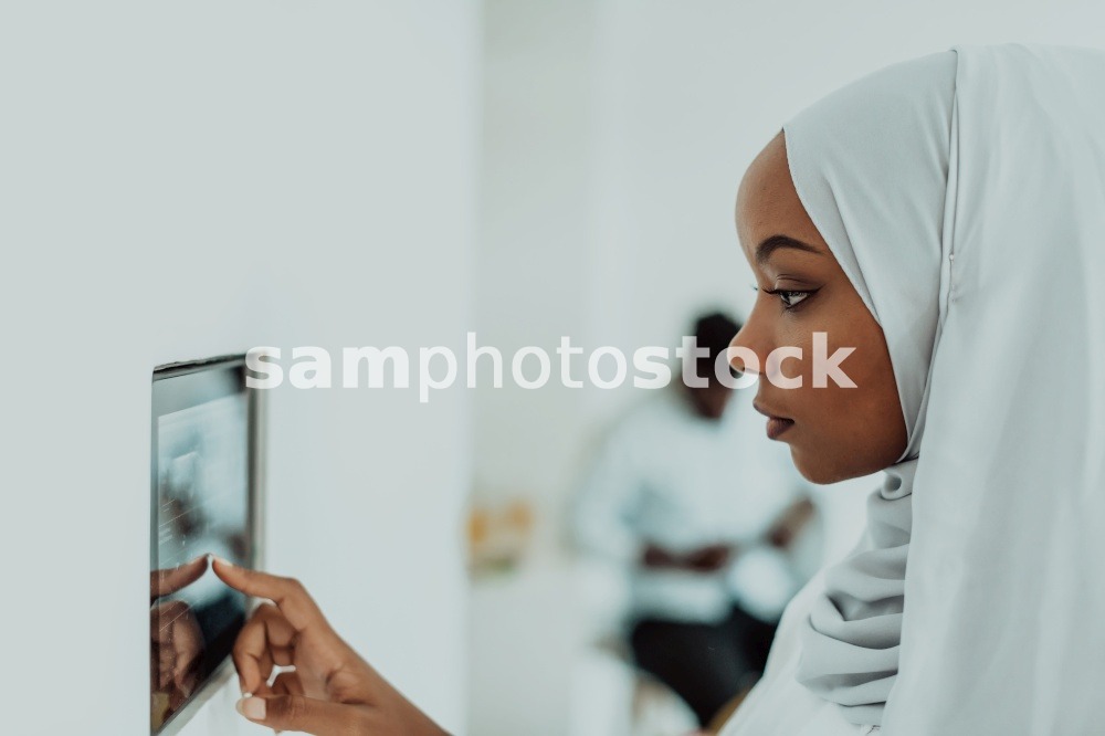 African woman using a smart home screen control system. High-quality photo. African woman using smart home screen control system