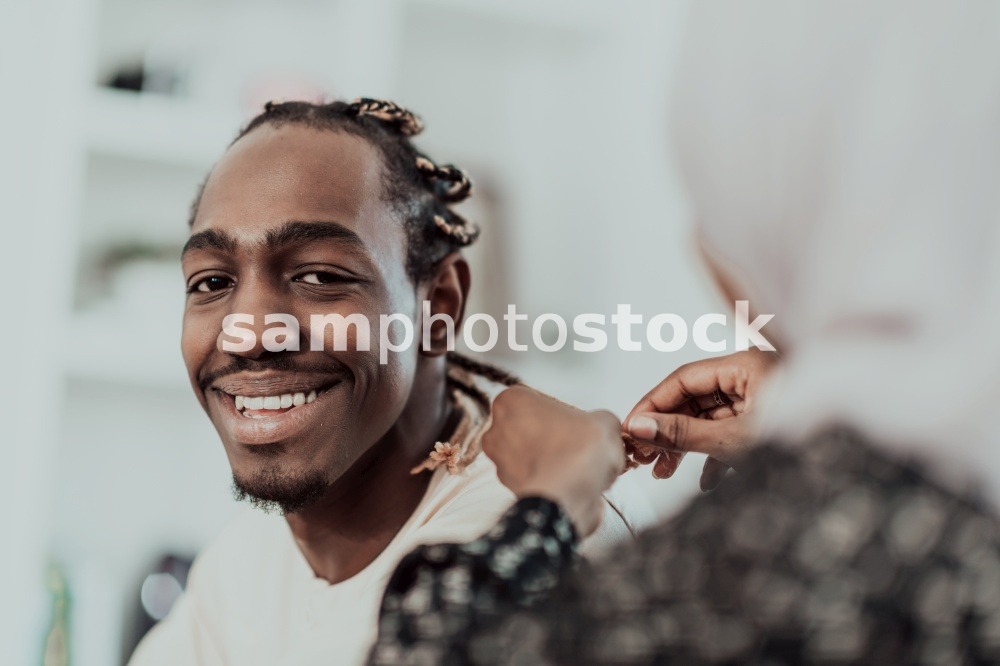 A young Muslim couple has a romantic time at home while the woman makes the hairstyle for her husband female wearing traditional Sudan Islamic hijab clothes. High-quality photo. A young Muslim couple has a romantic time at home while the woman makes the hairstyle for her husband female wearing traditional Sudan Islamic hijab clothes.